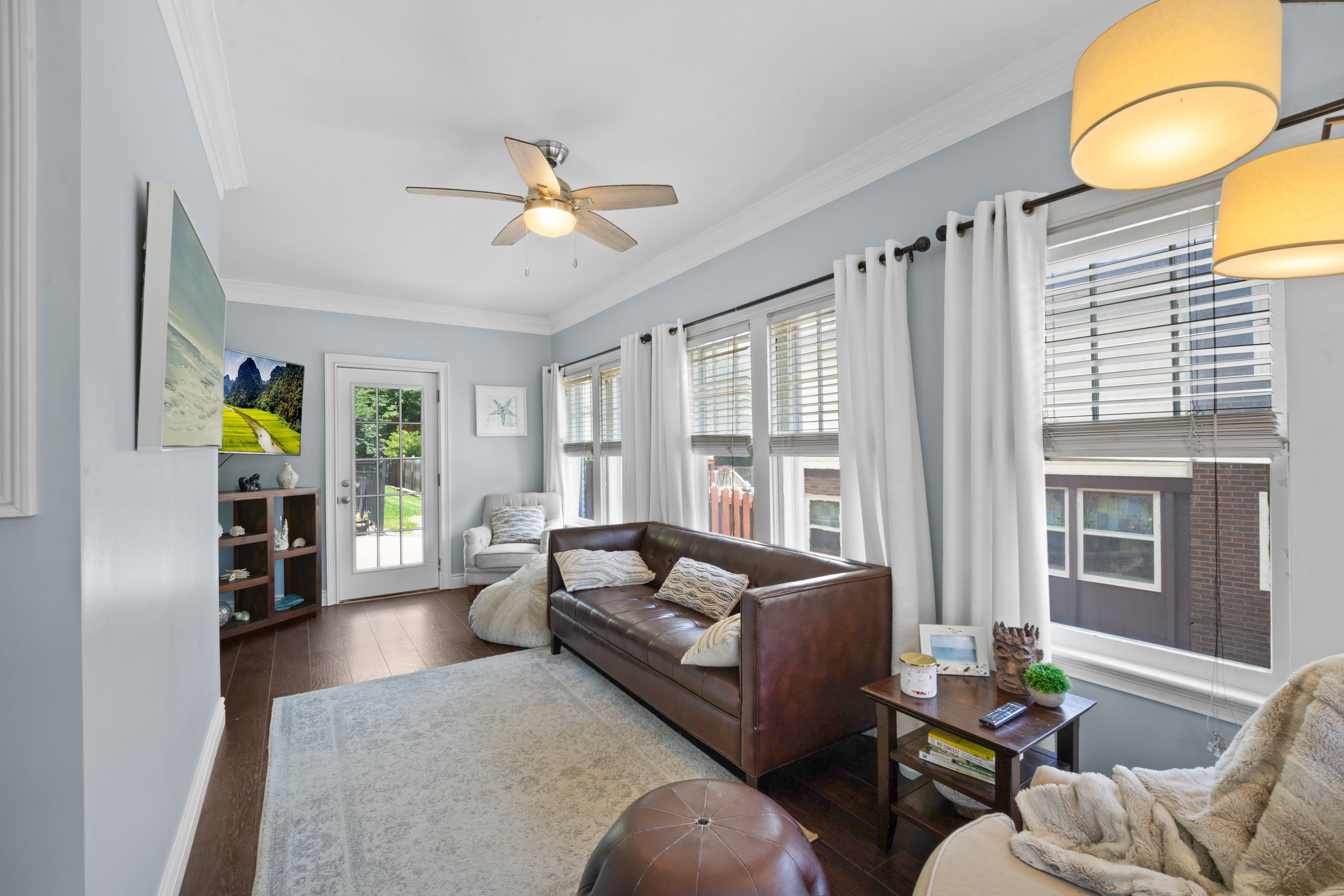 Living room with leather sofa and sunroom windows